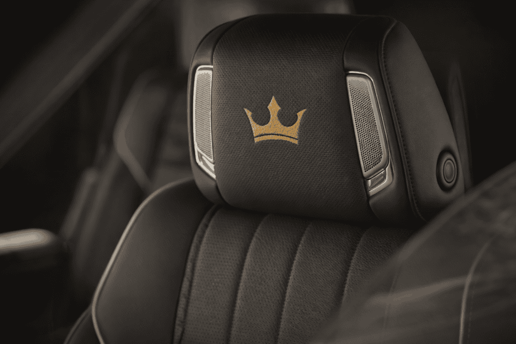 Headrest with Crown logo on luxury vehicle seat for chauffeur and executive transportation.