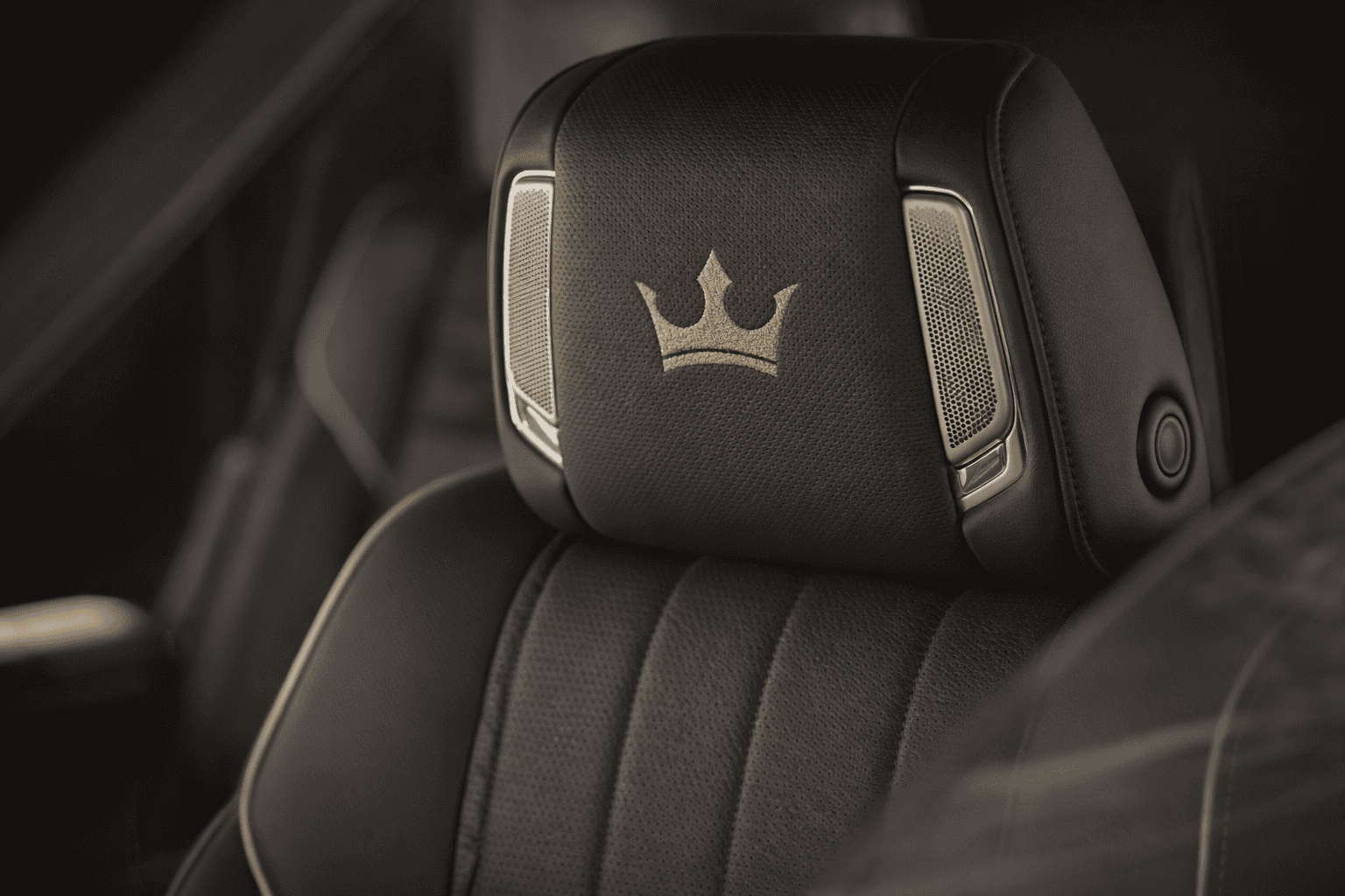 Headrest with Crown logo on dallas luxury fleet vehicle seat for chauffeur and executive transportation.