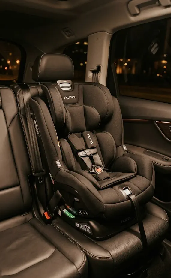 Child car seat installed in a Crown Concierge vehicle for a family airport trip